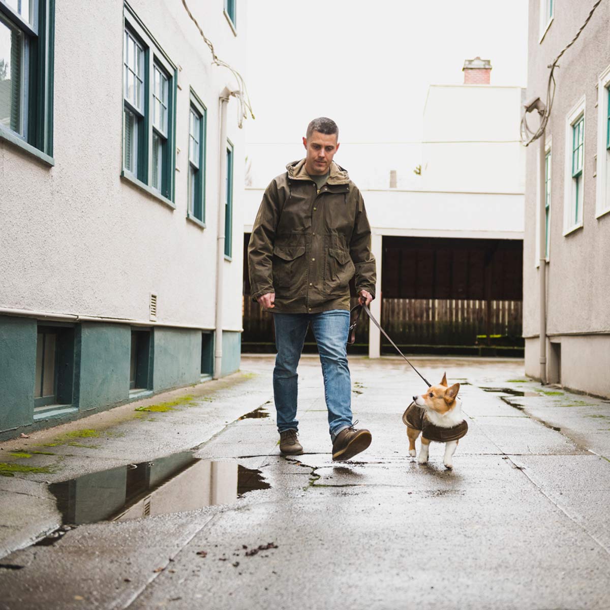 Otter Wax Founder Chris Chase Wearing Filson Raincoat Walking His Dog