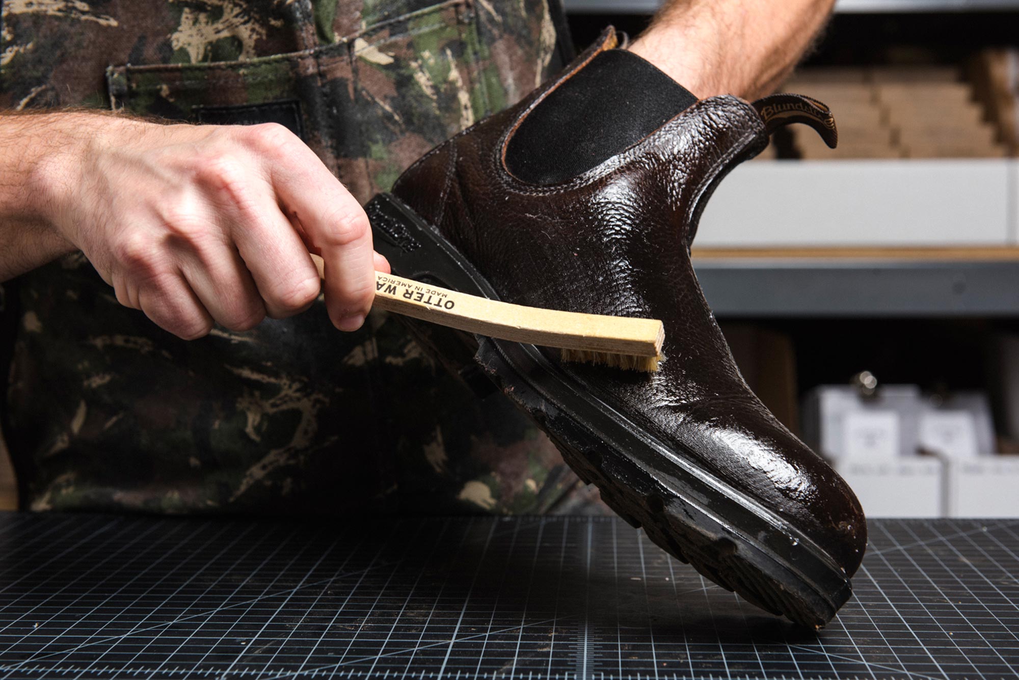 otter wax leather oil being buffed into leather with a small horsehair brush