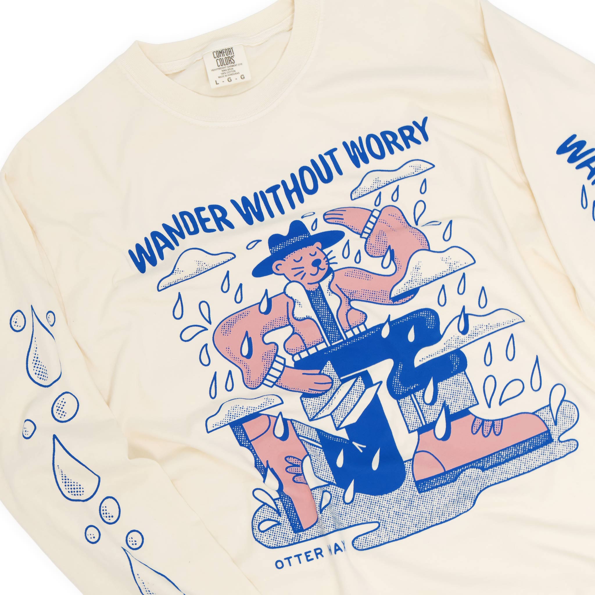 Ivory colored otter wax long-sleeve shirt with graphic design and text 'Wander Without Worry' on a white background