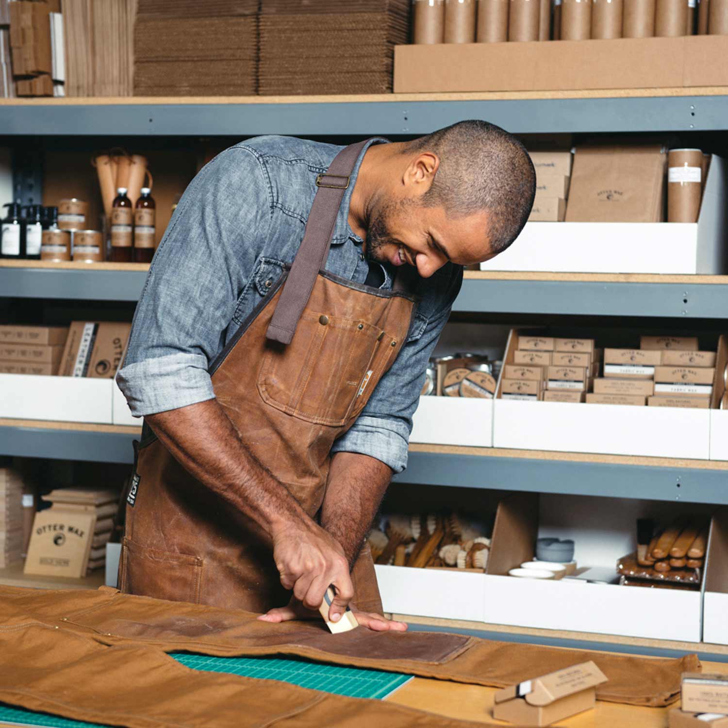 Otter Wax Employee Applying Fabric Wax To Carhartt Pants