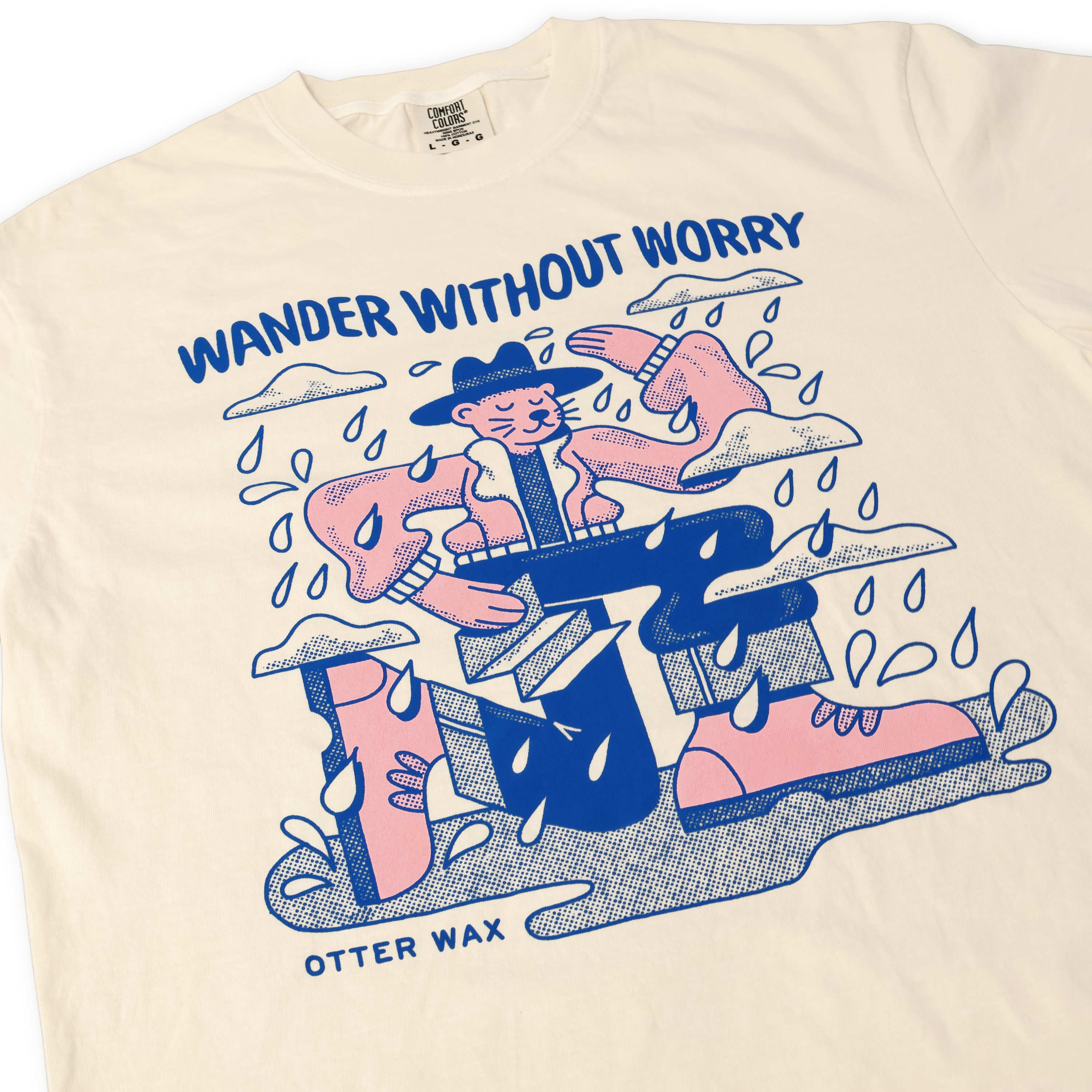 ivory colored otter wax  short sleeve shirt with graphic design and text 'Wander Without Worry' on a white background