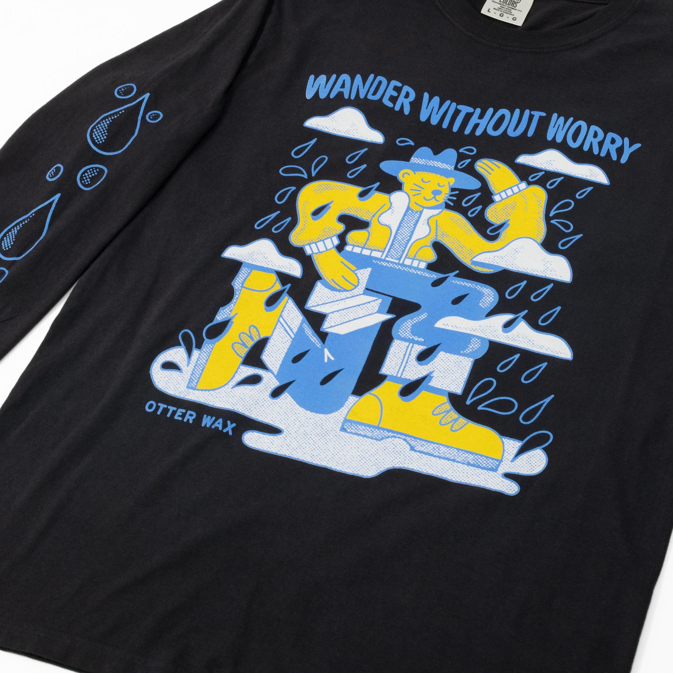 Black Otter Wax long sleeve t-shirt featuring a colorful “Wander Without Worry” graphic of an otter in outdoor gear surrounded by raindrops and clouds.